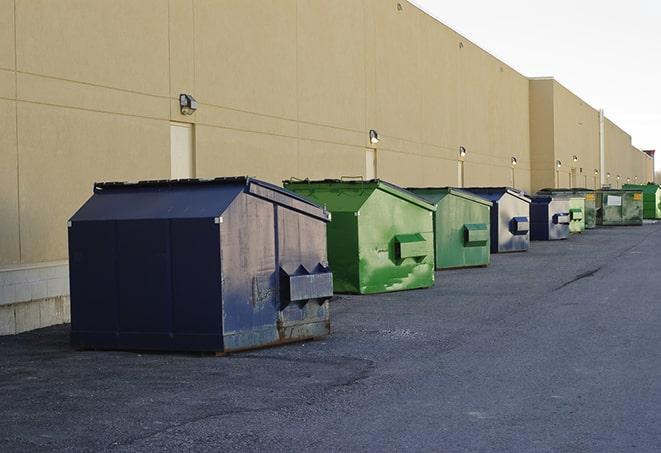 a collection of bright and vibrant dumpsters in a construction zone in Binghamton NY